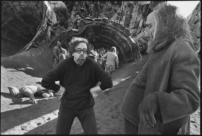 Tim Burton prepares for a scene with Paul Giamatti (in orangutan costume) in his remake of Planet of the Apes (2001). Mary Ellen Mark