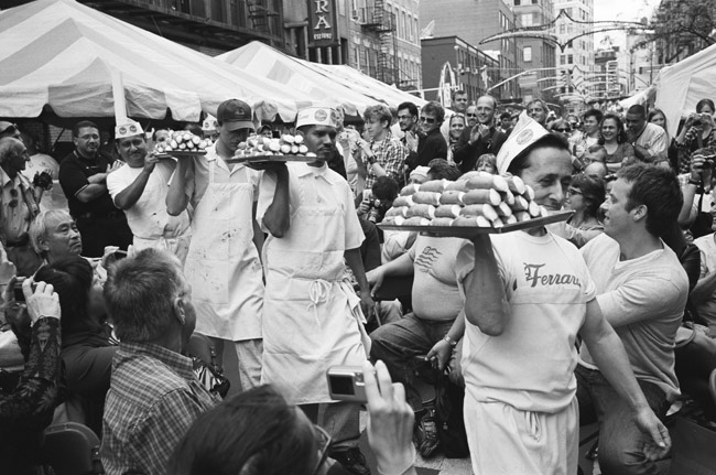 Cannoli Eating Competition, Annual Feast of San Gennaro, Little Italy; Leica M6 TTL 0.58, 35mm Summicron, Kodak Tri-x 400 © Doug Kim